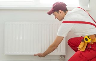 chauffagiste installant un nouveau radiateur